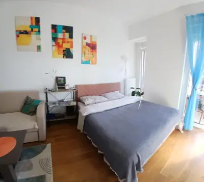 a bedroom with a bed and a couch at iwe in Banja Luka