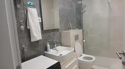 a bathroom with a toilet and a sink and a shower at iwe in Banja Luka