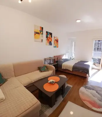 a living room with a couch and a bed at iwe in Banja Luka