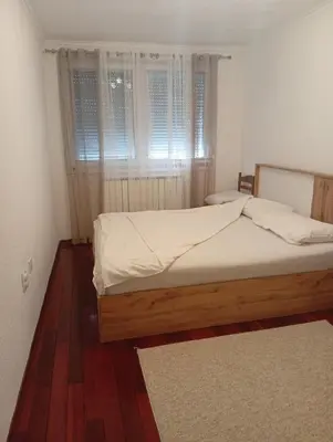 a bedroom with a bed and a window at Apartman Travnik in Travnik