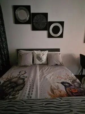 a bedroom with a bed with three pictures on the wall at Old Town Maglaj 2, Center ,Parking in Maglaj