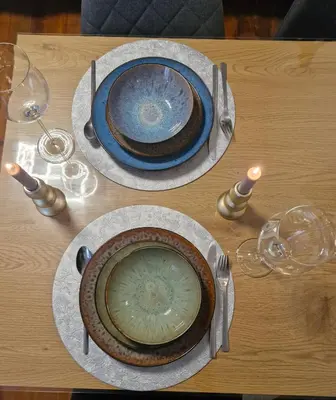 two plates and wine glasses on a wooden table at Old Town Maglaj 2, Center ,Parking in Maglaj