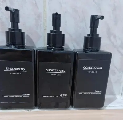 three bottles of shampoo and conditioner on a shelf at Old Town Maglaj 2, Center ,Parking in Maglaj