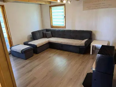 a living room with a couch and a table at Vikendica Neprivaj in Vareš