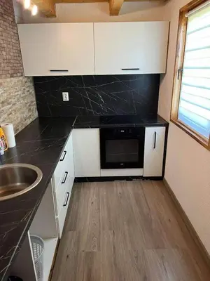 a kitchen with a sink and a microwave at Vikendica Neprivaj in Vareš