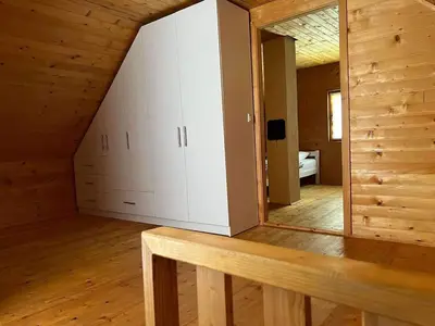 a room with white cabinets and a mirror at Vikendica Neprivaj in Vareš