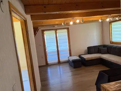 a living room with a couch and a table at Vikendica Neprivaj in Vareš