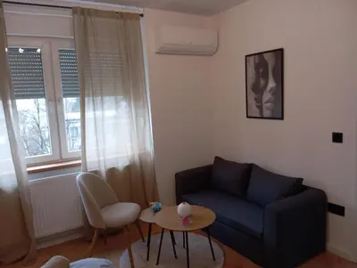 a living room with a couch and a table at Apartman Leky in Tuzla