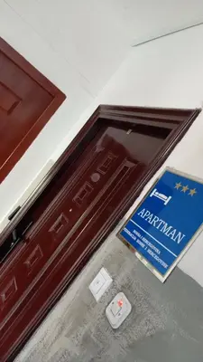 a door with a sign on top of it at Apartman Leky in Tuzla