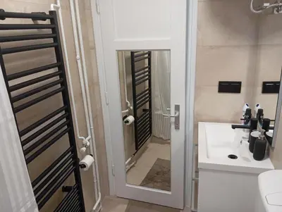 a bathroom with a toilet and a sink and a mirror at Apartman Leky in Tuzla