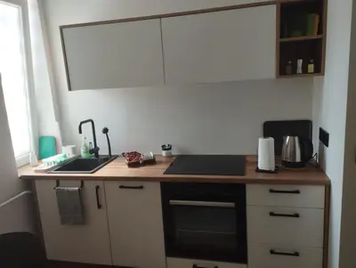 a kitchen with a counter with a sink and a stove at Apartman Leky in Tuzla