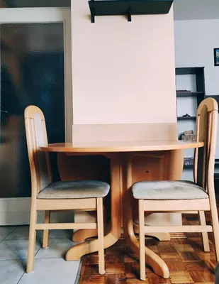 two chairs around a wooden table with a desk at Sunny Banja Luka in Banja Luka