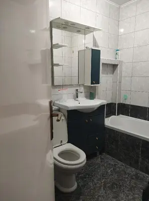 a bathroom with a toilet and a sink and a tub at Sunny Banja Luka in Banja Luka