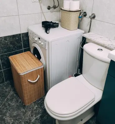 a bathroom with a toilet and a washing machine at Sunny Banja Luka in Banja Luka