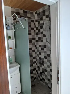 a bathroom with a shower with a sink and a toilet at Studio apartman MA Kostajnica in Kostajnica