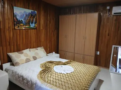 a bedroom with a bed with a blanket on it at Studio apartman MA Kostajnica in Kostajnica