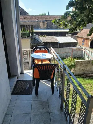 a table and chairs sitting on a balcony at Studio apartman MA Kostajnica in Kostajnica
