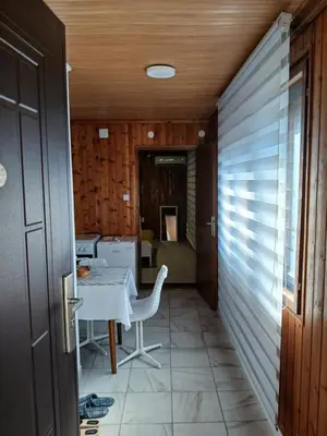 a hallway with a table and chairs in a house at Studio apartman MA Kostajnica in Kostajnica