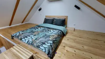 a bedroom with a bed in the corner of a room at Kovačnica 55