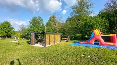 a small playground with a play house and a slide at Kovačnica 55