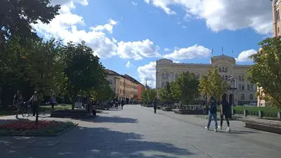 a city street with people walking down the street at Luxury Palata Penthouse Apartments in Banja Luka