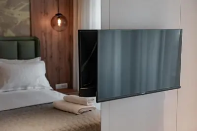 a flat screen tv sitting on top of a bed at Luxury Palata Penthouse Apartments in Banja Luka
