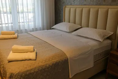 a large white bed with two pillows on it at Luxury Palata Penthouse Apartments in Banja Luka