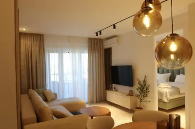 a living room with a couch and a bed at Luxury Palata Penthouse Apartments in Banja Luka