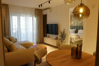 a living room with a couch and a table at Luxury Palata Penthouse Apartments in Banja Luka