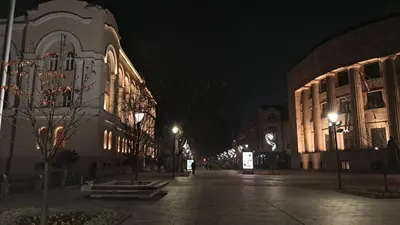 a city street at night with buildings and lights at Luxury Palata Penthouse Apartments in Banja Luka