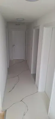an empty room with a white floor and a door at Apartment Sikira in Visoko