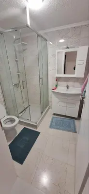 a bathroom with a shower and a toilet and a sink at Apartment Sikira in Visoko
