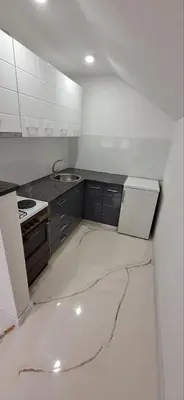 a white kitchen with a stove and a sink at Apartment Sikira in Visoko