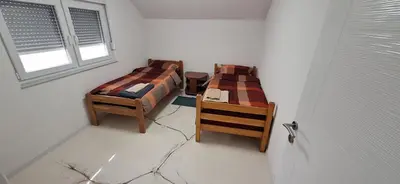 a room with two beds and a window at Apartment Sikira in Visoko