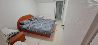 a small bedroom with a bed and a window at Apartment Sikira in Visoko