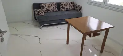a living room with a couch and a table at Apartment Sikira in Visoko