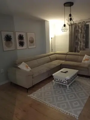 a living room with a couch and a coffee table at Apartman AM Tuzla in Tuzla