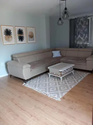 a living room with a couch and a coffee table at SlatinaApartman in Tuzla