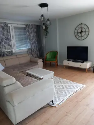 a living room with a couch and a flat screen tv at SlatinaApartman in Tuzla