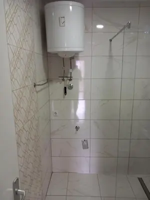 a bathroom with a shower with a glass door at SlatinaApartman in Tuzla