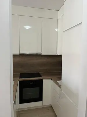 a kitchen with white cabinets and a microwave at Elly in Modriča