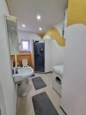 a bathroom with a sink and a toilet and a shower at Sobe Kod Ćobe in Matuzići