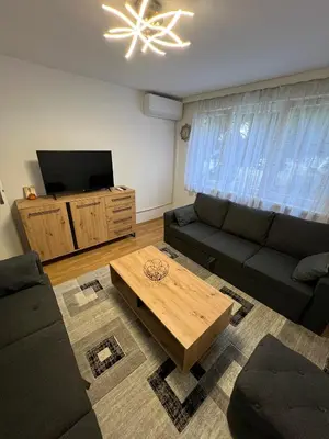 a living room with a couch and a tv at Tajni kutak in Bosanska Gradiška