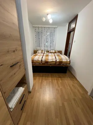a bedroom with a bed in the corner of a room at Tajni kutak in Bosanska Gradiška