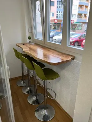 a bar with green stools next to a window at Tajni kutak in Bosanska Gradiška