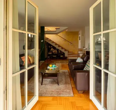 a living room with a couch and a staircase at Villa Garden in Banja Luka