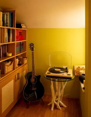 a room with a table with a guitar and a laptop at Villa Garden in Banja Luka