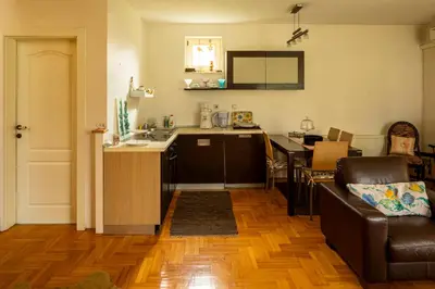 a kitchen and living room with a couch and a table at Villa Garden in Banja Luka