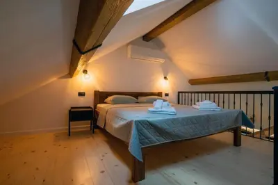 a bedroom with a bed with towels on it at Apartman Rustic Charm in Livno