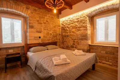 a bedroom with a bed with towels on it at Apartman Rustic Charm in Livno